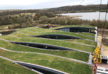 The underlying structure for the extensive wildflower meadow roof is constructed from a series of interconnected glulam beams, manufactured by fixing timber boards together and forming them into the curved sections.